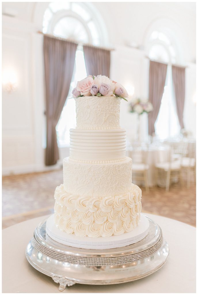 A white wedding cake with flowers.