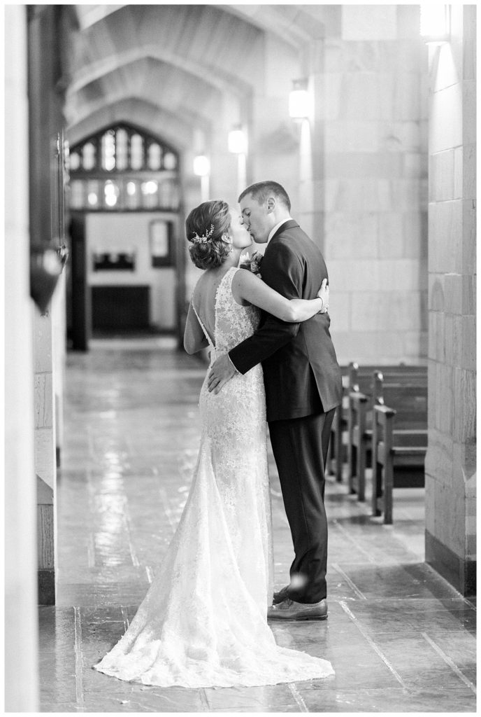 A bride and groom sharing a kiss after their wedding ceremony.