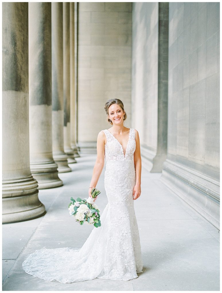An elegant Pittsburgh bride posing for portraits at Carnegie Library.