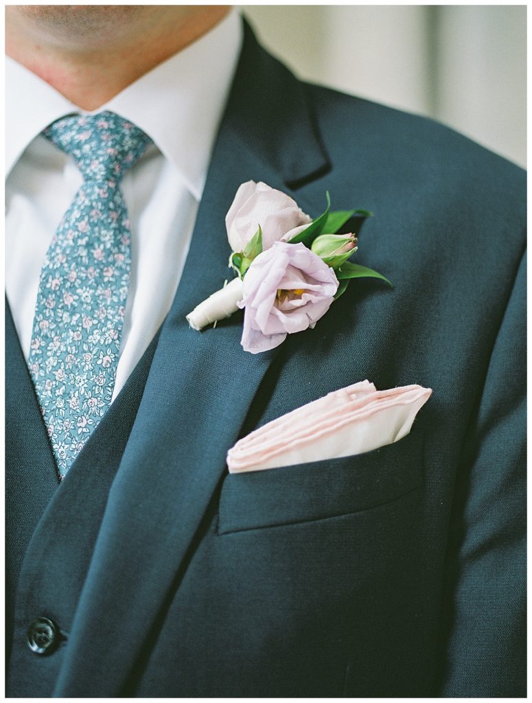 A detail shot of a groom's colorful tie and boutonniere. 